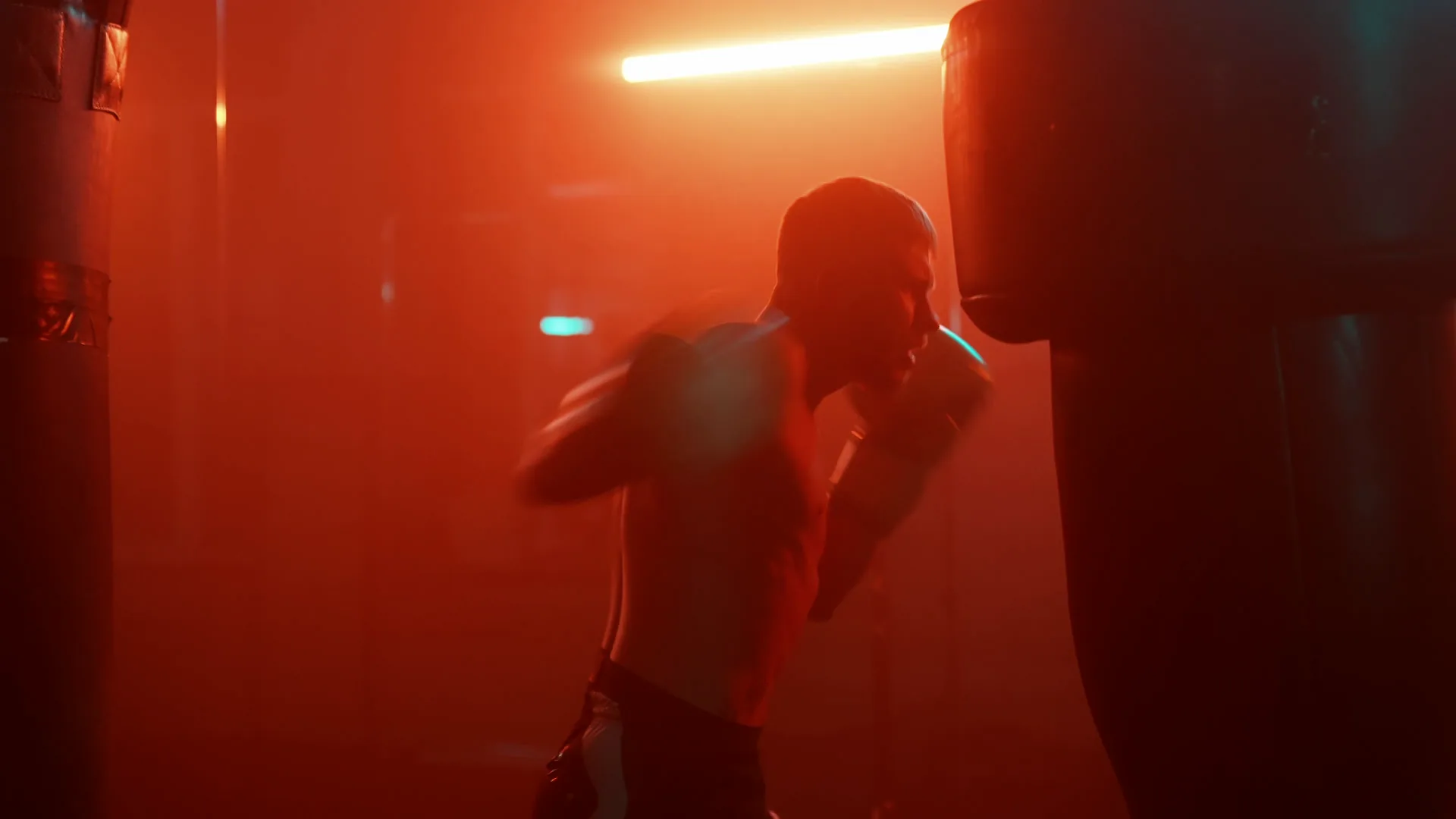 A heavy bag under red light at the Alpha Beast Fitness studio