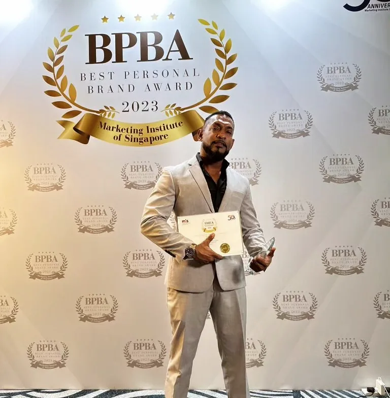 EJ Philip holding the BPBA Best Personal Brand Award 2023